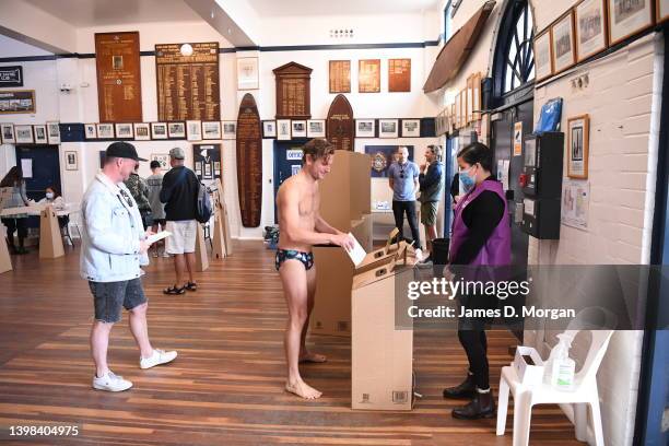 Man wearing swimwear votes inside Bondi Surf Bathers Life Saving Club in the electorate of Wentworth on May 21, 2022 in Sydney, Australia....