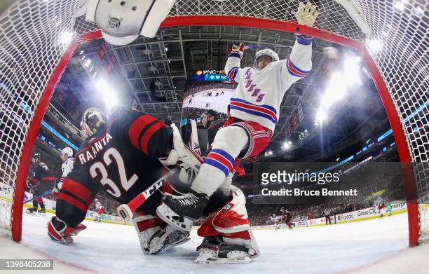 Andrew Copp of the New York Rangers gets tangled up with Antti Raanta of the Carolina Hurricanes during the third period in Game Two of the Second...
