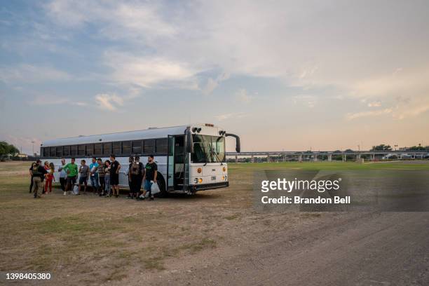 Migrants prepare to board a Border Patrol bus on May 20, 2022 in Eagle Pass, Texas. Title 42, the controversial pandemic-era border policy enacted by...