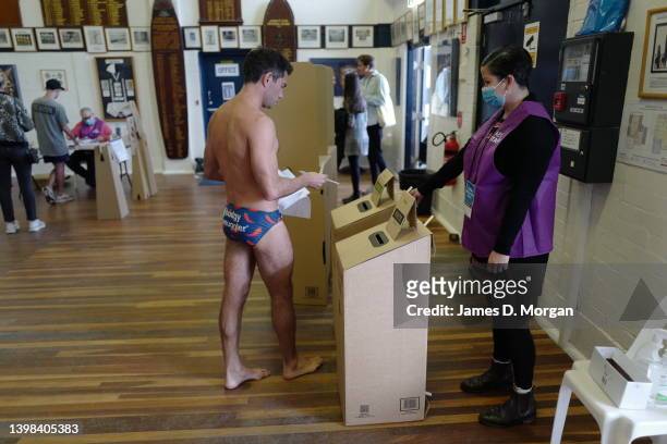 Man wearing swimwear votes inside Bondi Surf Bathers Life Saving Club in the electorate of Wentworth on May 21, 2022 in Sydney, Australia....