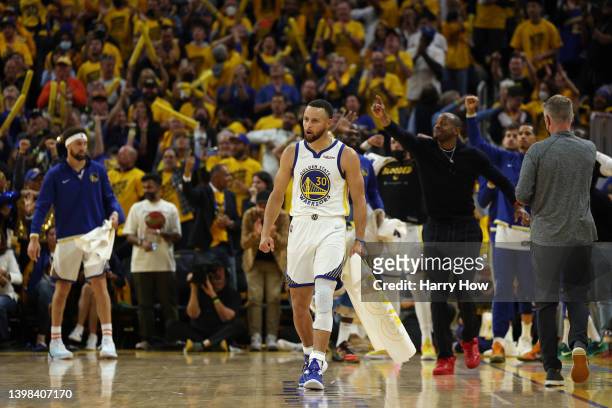 Stephen Curry of the Golden State Warriors celebrates a basket by teammate Otto Porter Jr. #32 during the fourth quarter against the Dallas Mavericks...