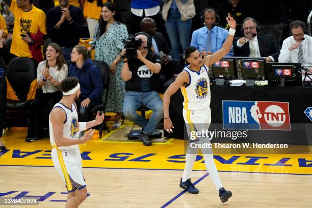 Klay Thompson and Jordan Poole of the Golden State Warriors celebrate a three point basket by Poole during the fourth quarter against the Dallas...