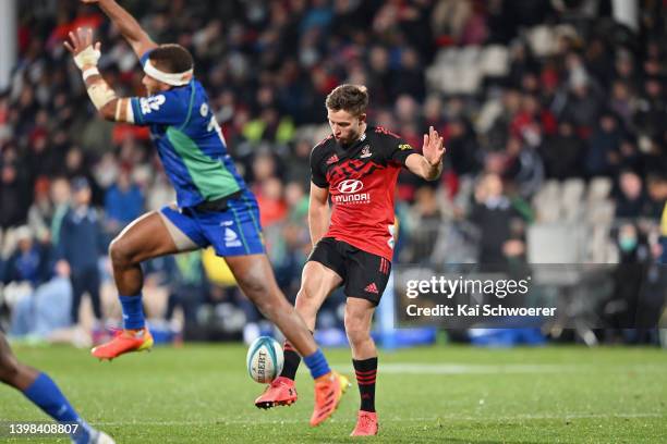 Fergus Burke of the Crusaders kicks the ball during the round 14 Super Rugby Pacific match between the Crusaders and the Fijian Drua at Orangetheory...