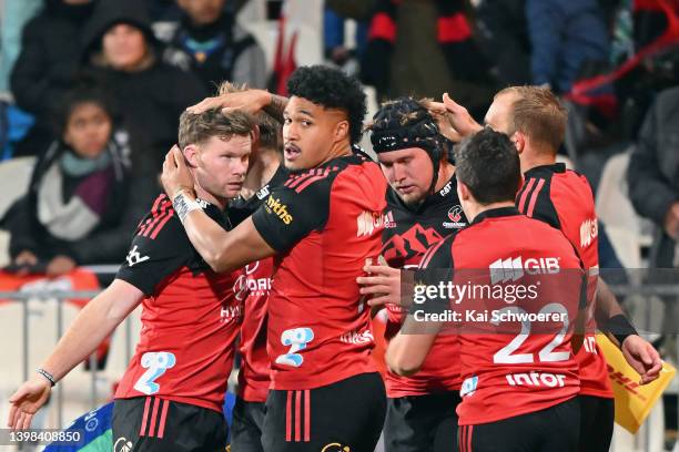 Mitchell Drummond, Leicester Fainga' anuku and Corey Kellow of the Crusaders celebrate after Braydon Ennor of the Crusaders scores a try during the...