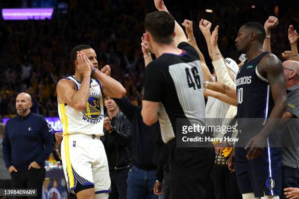 Stephen Curry of the Golden State Warriors celebrates a three point basket in front of the Dallas Mavericks bench during the fourth quarter in Game...