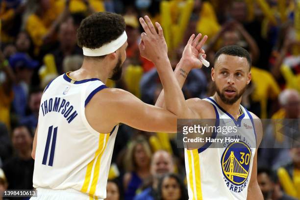 Stephen Curry and Klay Thompson of the Golden State Warriors celebrate a basket during the fourth quarter against the Dallas Mavericks in Game Two of...
