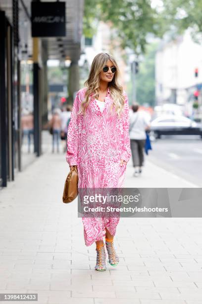 Influencer Gitta Banko wearing a pink and white maxi dress with abstract pattern by Sem Per Lei, multicolored high heel sandals by Sophia Webster, a...