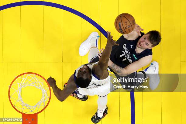 Luka Doncic of the Dallas Mavericks shoots the ball against Draymond Green of the Golden State Warriors during the second half during the fourth...