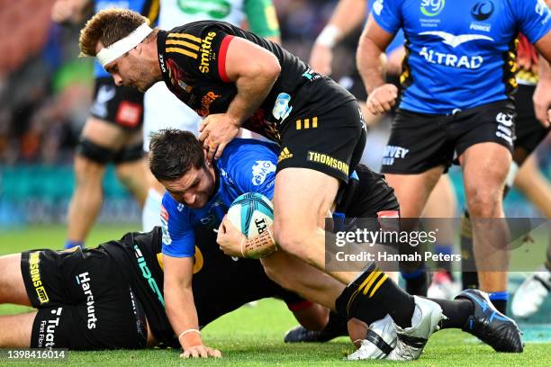 Sam Cane of the Chiefs injures his ankle in a tackle during the round 14 Super Rugby Pacific match between the Chiefs and the Western Force at FMG...