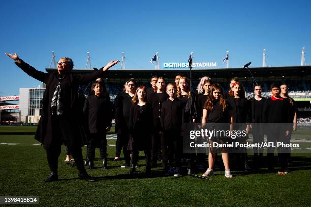 Choir perform the Cats team song before the round 10 AFL match between the Geelong Cats and the Port Adelaide Power at GMHBA Stadium on May 21, 2022...