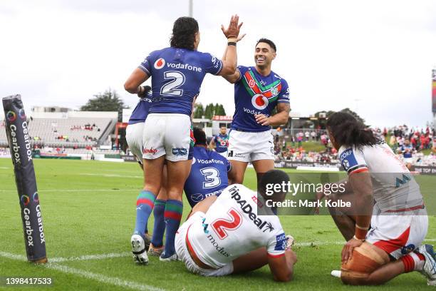 Dallin Watene-Zelezniak and Shaun Johnson of the Warriors celebrate Viliami Vailea of the Warriors scoring a try during the round 11 NRL match...