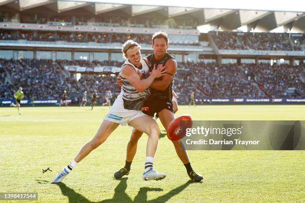 Zach Guthrie of the Cats and Steven Motlop of the Power compete during the round 10 AFL match between the Geelong Cats and the Port Adelaide Power at...