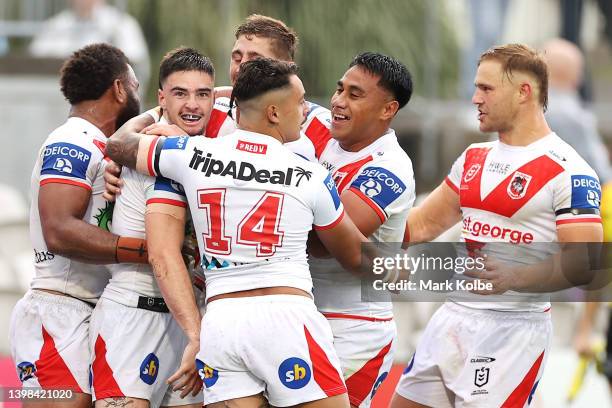 Cody Ramsey of the Dragons celebrates with his team mates after scoring a try during the round 11 NRL match between the St George Illawarra Dragons...