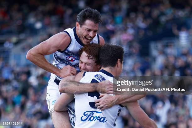 Jeremy Cameron of the Cats celebrates with Gary Rohan of the Cats and Isaac Smith of the Cats after kicking a goal on the three quarter time siren...