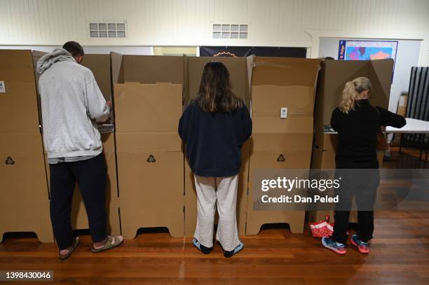 People cast their votes at a polling booth on May 21, 2022 in Brisbane, Australia. Australians head to the polls today to elect the 47th Parliament...