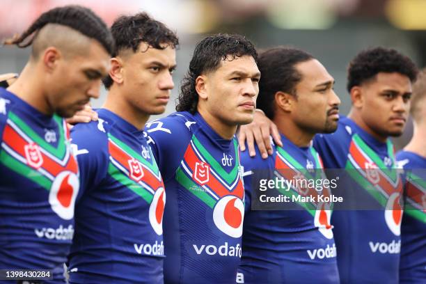 Dallin Watene-Zelezniak of the Warriors stands with his team during a pre-match ceremony in memory of St George legend John Raper before play in the...