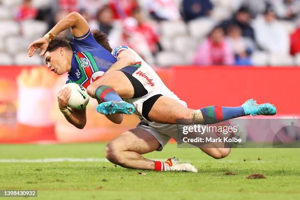 Reece Walsh of the Warriors is tackled during the round 11 NRL match between the St George Illawarra Dragons and the New Zealand Warriors at...