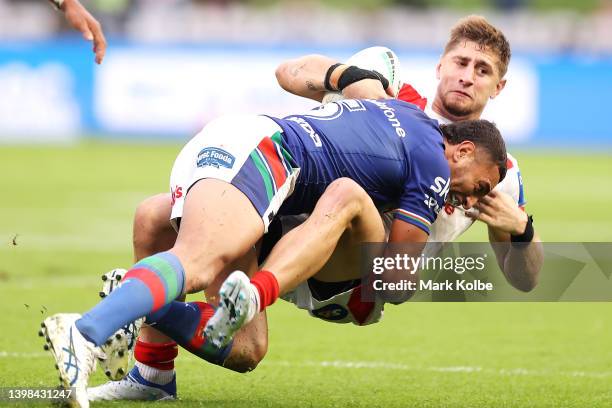 Zac Lomax of the Dragons is tackled by Marcelo Montoya of the Warriors during the round 11 NRL match between the St George Illawarra Dragons and the...