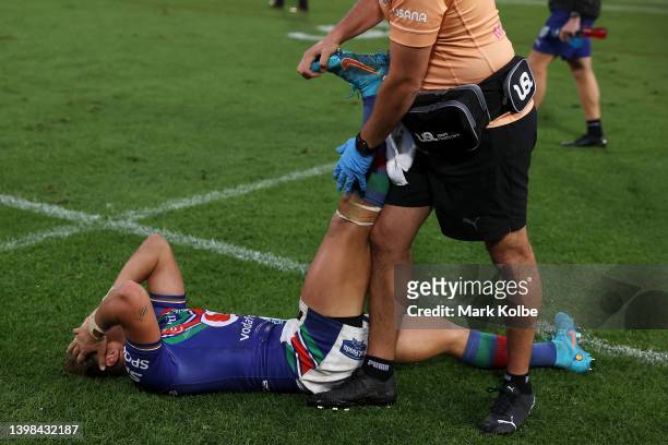 Reece Walsh of the Warriors receives attention from the trainer after full time during the round 11 NRL match between the St George Illawarra Dragons...