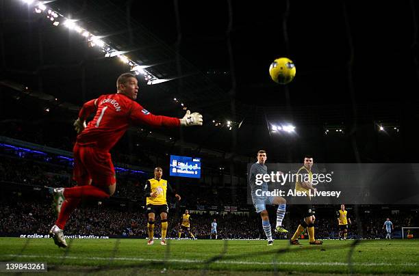 Edin Dzeko of Manchester City scores his team's third goal during the Barclays Premier League match between Manchester City and Blackburn Rovers at...