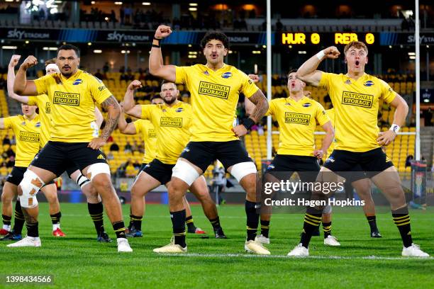 To R, Isaia Walker-Leawere, Te Kamaka Howden and Ruben Love of the Hurricanes perform a haka during the round 14 Super Rugby Pacific match between...