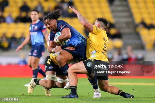 Pone Fa’amausili of the Rebels is tackled during the round 14 Super Rugby Pacific match between the Hurricanes and the Melbourne Rebels at Sky...