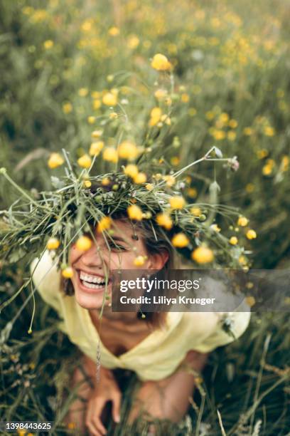 happy woman with a flower wreath on her had. - summer woman stock pictures, royalty-free photos & images