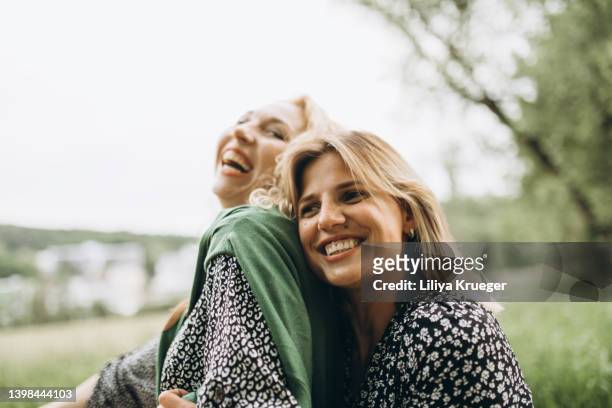 two happy woman. - couple in nature stock-fotos und bilder