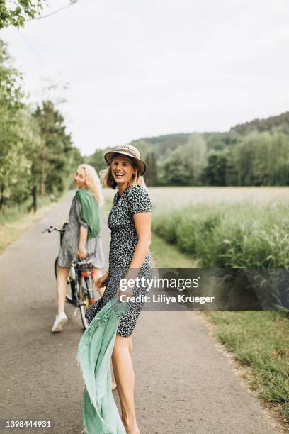 two happy woman. - fahrrad frau außen lächeln stock-fotos und bilder