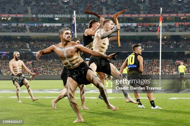 Richmond Indigenous players Sydney Stack, Matthew Parker, Marlion Pickett and Shane Edwards of the Tigers take part in performance before during the...