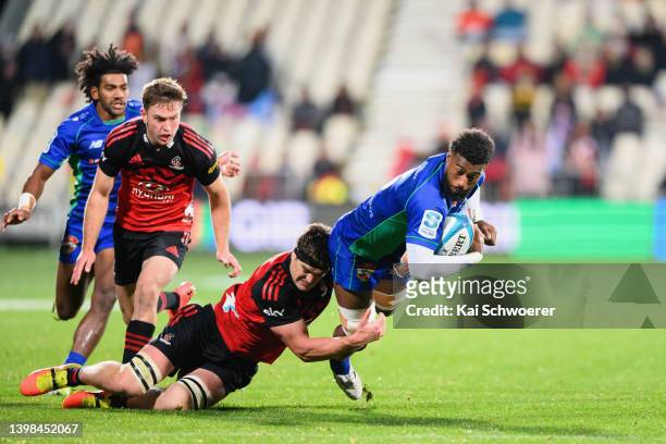 Joseva Tamani of Fijian Drua is tackled by Scott Barrett of the Crusaders during the round 14 Super Rugby Pacific match between the Crusaders and the...