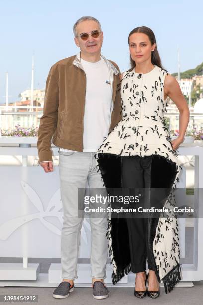 Olivier Assayas and Alicia Vikander attend the photocall for "Irma Vep" during the 75th annual Cannes film festival at Palais des Festivals on May...