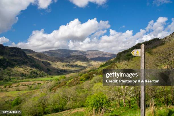 footpath sign pointing to beautiful scenery in the snowdonia national park, north wales - footpath sign stock pictures, royalty-free photos & images