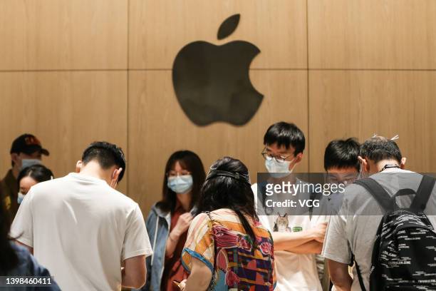 Customers try out Apple products inside a new Apple store at Wuhan International Plaza on May 21, 2022 in Wuhan, Hubei Province of China.