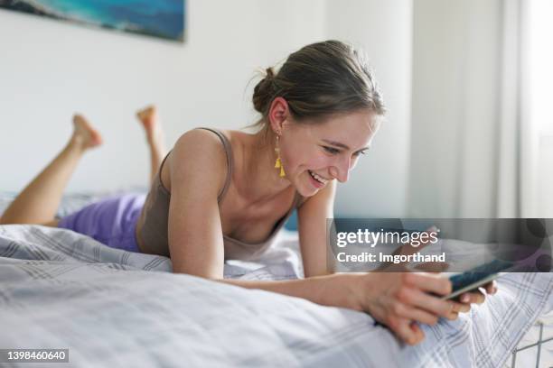 teenage girl reading a funny e-book at home - e girls stock pictures, royalty-free photos & images