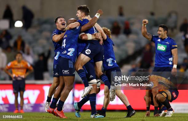 Beauden Barrett of the Blues celebrates kicking a field goal on full time to win the round 14 Super Rugby Pacific match between the ACT Brumbies and...
