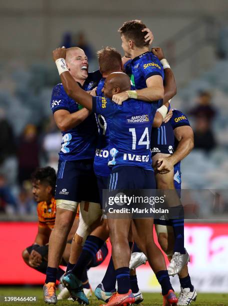 Beauden Barrett of the Blues celebrates kicking a field goal on full time to win the round 14 Super Rugby Pacific match between the ACT Brumbies and...