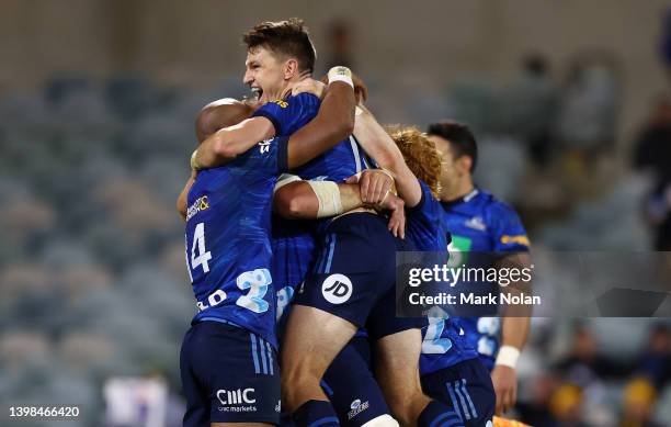 Beauden Barrett of the Blues celebrates kicking a field goal on full time to win the round 14 Super Rugby Pacific match between the ACT Brumbies and...