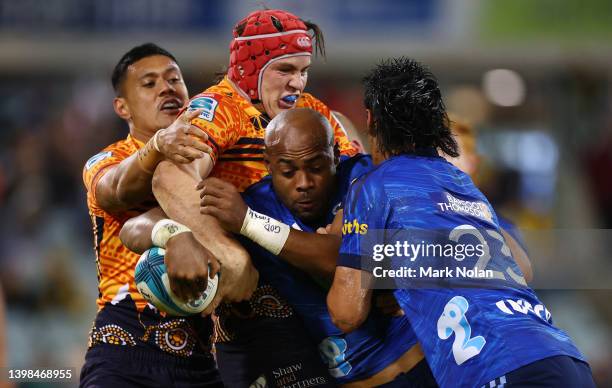 Mark Telea of the Blues is tackled during the round 14 Super Rugby Pacific match between the ACT Brumbies and the Blues at GIO Stadium on May 21,...