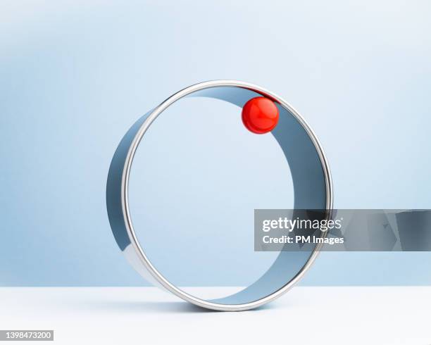 red ball riding metal ring - speed accuracy stock pictures, royalty-free photos & images