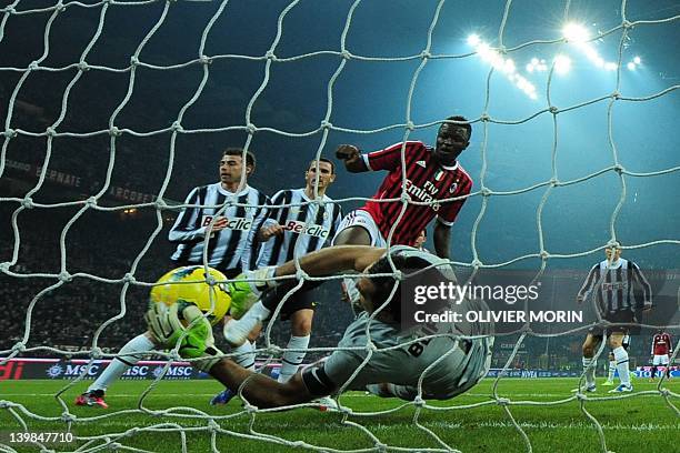 Juventus goalkeeper Gianluigi Buffon grabs the ball in front of AC Milan midfielder Sulley Ali Muntari of Ghana on February 25, 2012 during a Serie A...