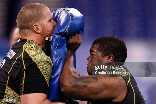 Offensive linemen Philip Blake of Baylor and Tony Bergstrom of Utah take part in a drill during the 2012 NFL Combine at Lucas Oil Stadium on February...