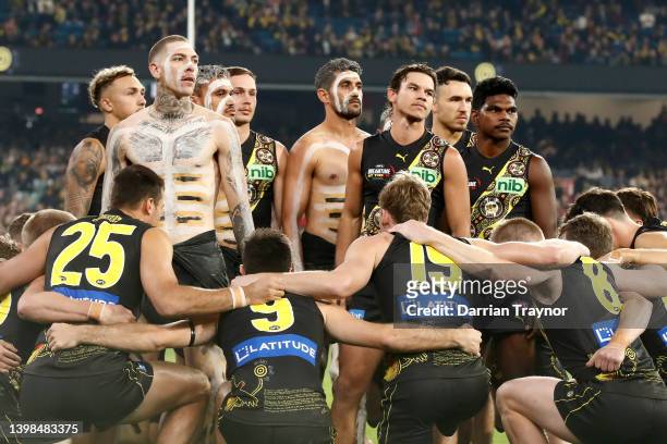 Richmond players take part in an Indigenous dance before the round 10 AFL match between the Richmond Tigers and the Essendon Bombers at Melbourne...