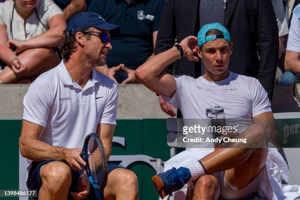 Coach Carlos Moya of Spain is seen during a practice session of Rafael Nadal of Spain prior to the start of 2022 French Open at Roland Garros on May...