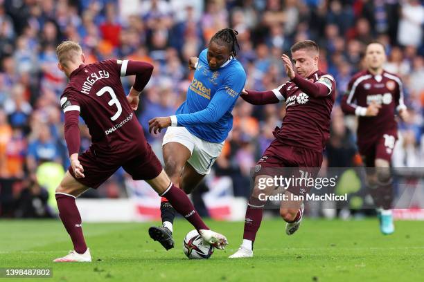 Joe Aribo of Rangers is challenged by Stephen Kingsley and Cameron Devlin of Heart of Midlothian during the Scottish Cup Final match between Rangers...