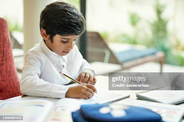 saudi schoolboy doing homework - saudi arabien bildbanksfoton och bilder