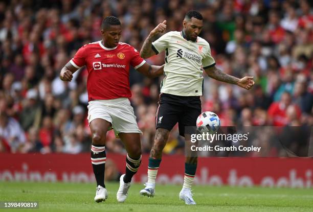 Jermaine Pennant of Liverpool is tackled by Antonio Valencia of Manchester UNited during the Legends of the North match between Manchester United and...