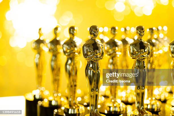 group of golden statuette on shiny yellow background - first light awards stockfoto's en -beelden