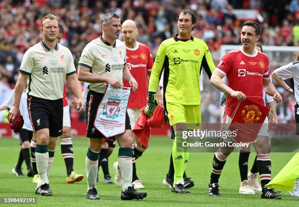 Captains Gary Neville of Manchester United and Jamie Carragher of Liverpool led out their teams ahead of the Legends of the North match between...