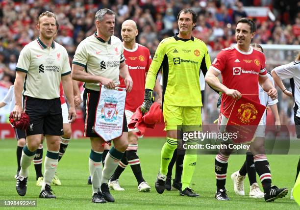 Captains Gary Neville of Manchester United and Jamie Carragher of Liverpool led out their teams ahead of the Legends of the North match between...